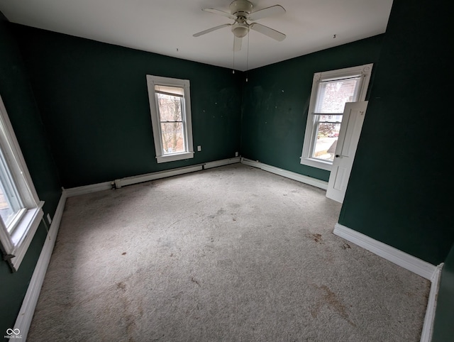 unfurnished room featuring baseboard heating, ceiling fan, and carpet floors