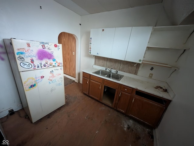 kitchen with white fridge, tasteful backsplash, and sink