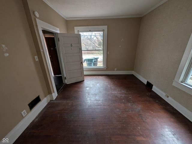 spare room featuring dark hardwood / wood-style flooring and ornamental molding