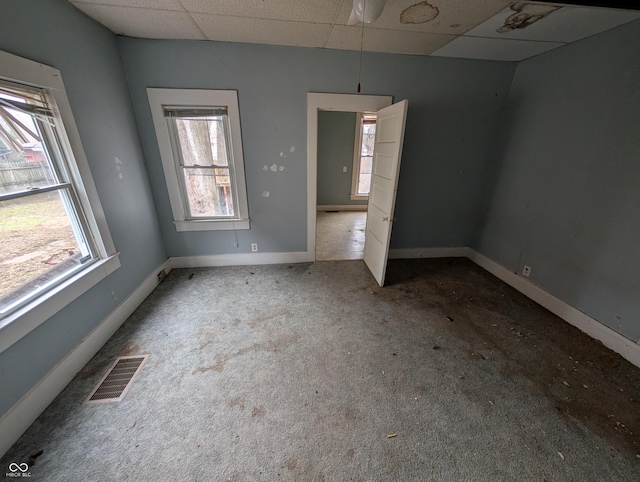 spare room with a paneled ceiling and ceiling fan