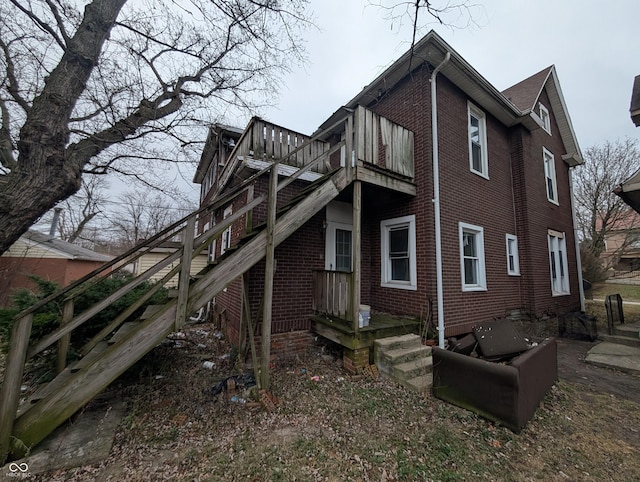 view of side of property with a balcony