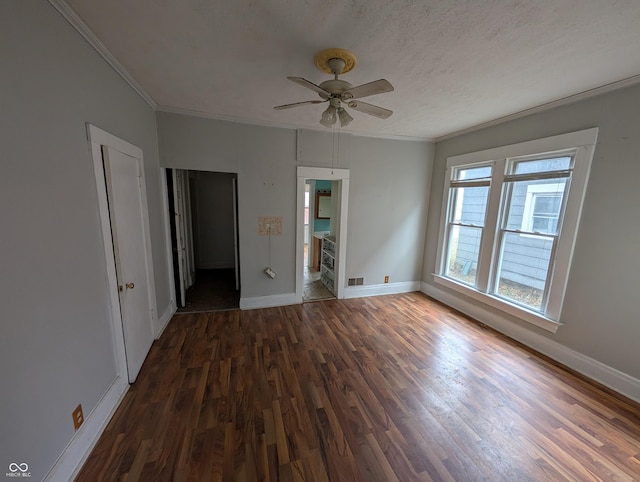 interior space featuring ensuite bathroom, a textured ceiling, ceiling fan, crown molding, and dark hardwood / wood-style floors