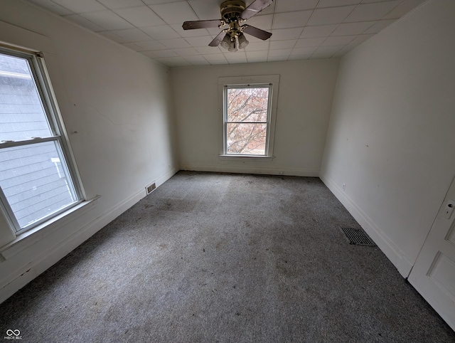 spare room with ceiling fan and carpet floors