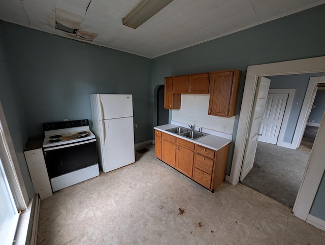 kitchen with light carpet, sink, and white appliances