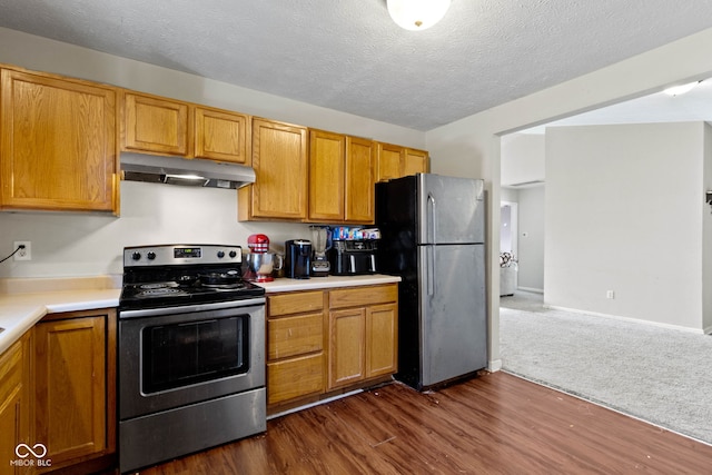 kitchen featuring a textured ceiling, dark hardwood / wood-style flooring, and stainless steel appliances