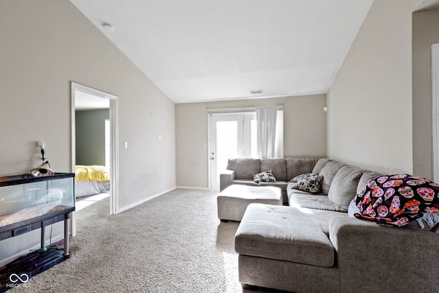 carpeted living room with lofted ceiling