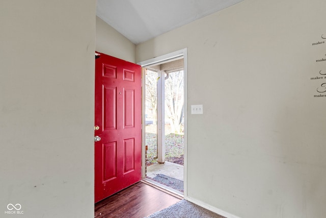 entrance foyer featuring dark hardwood / wood-style flooring and lofted ceiling