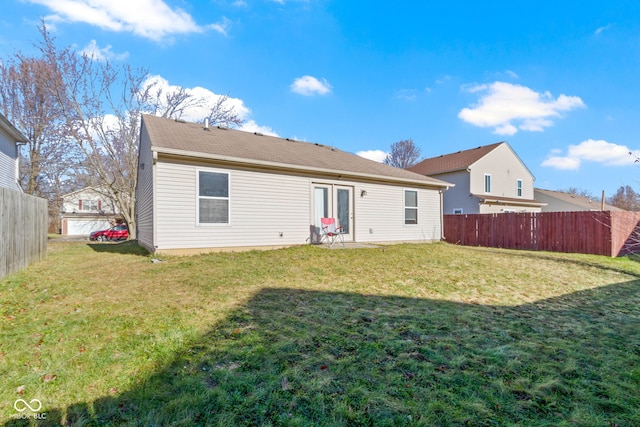 back of house with a yard