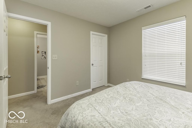 bedroom featuring light carpet