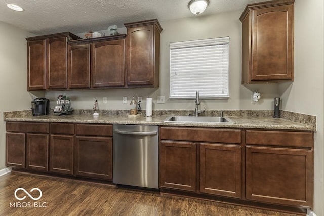 kitchen featuring stainless steel dishwasher, a textured ceiling, sink, and dark wood-type flooring