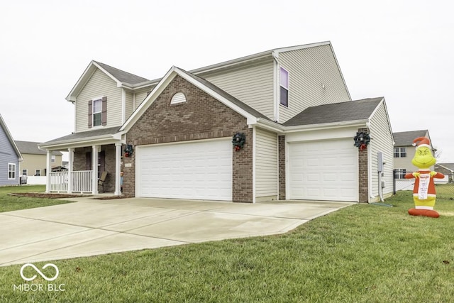 front of property featuring covered porch, a garage, and a front lawn