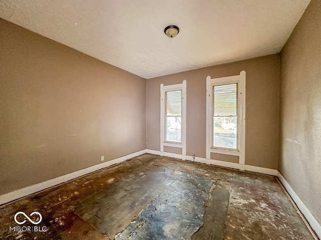 spare room with a textured ceiling