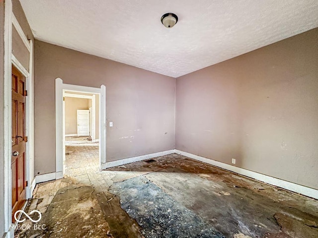 empty room featuring a textured ceiling