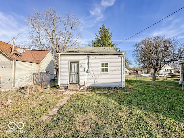 rear view of property with a yard