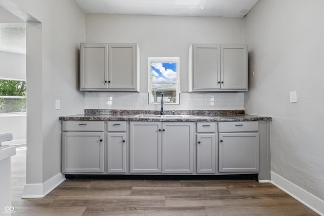 2218 N Arsenal Ave, Indianapolis, IN 46218 - kitchen featuring dark countertops, tasteful backsplash, and dark wood-style floors