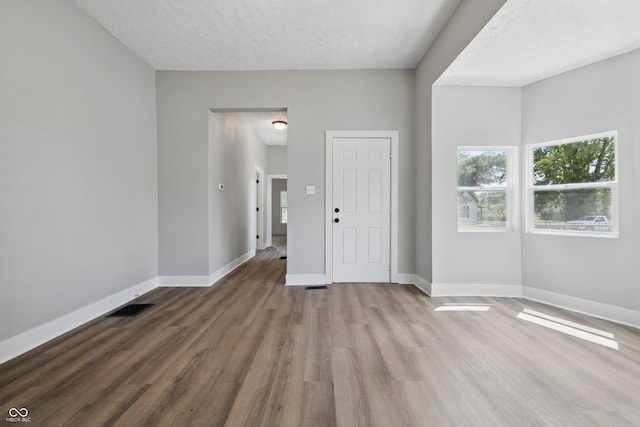2218 N Arsenal Ave, Indianapolis, IN 46218 - empty room with wood finished floors and a textured ceiling