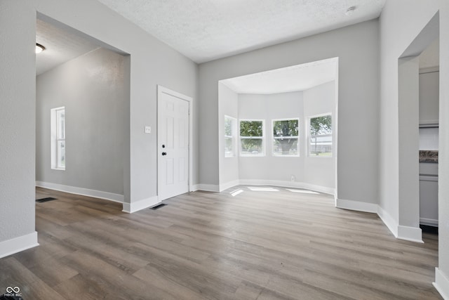 2218 N Arsenal Ave, Indianapolis, IN 46218 - foyer entrance with wood finished floors and a textured ceiling