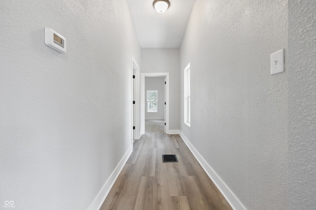 2218 N Arsenal Ave, Indianapolis, IN 46218 - hallway with wood finished floors and a textured wall