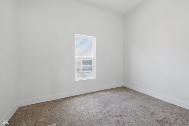 2218 N Arsenal Ave, Indianapolis, IN 46218 - spare room featuring carpet floors and baseboards