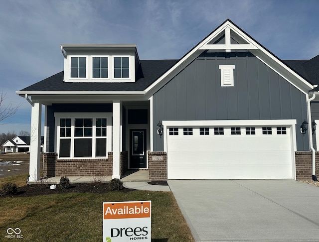 craftsman-style house with a garage, a porch, and a front lawn