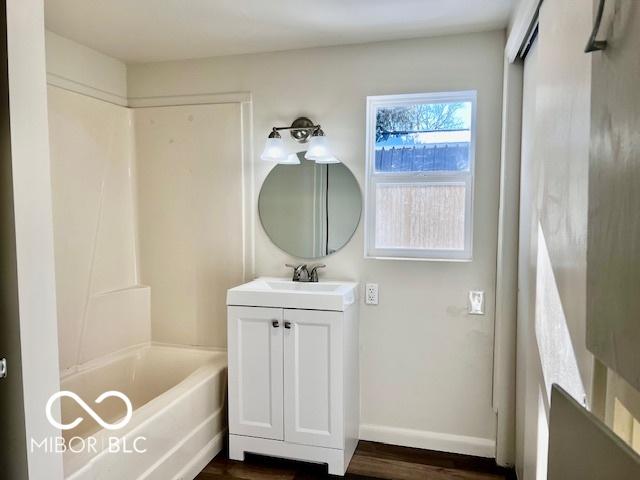 bathroom featuring tub / shower combination, wood-type flooring, and vanity