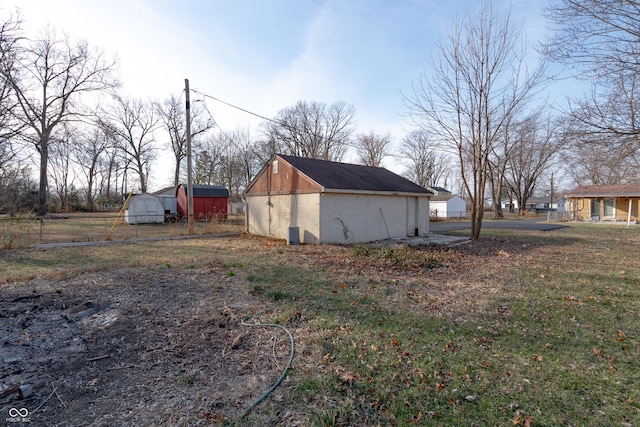 view of side of property featuring an outbuilding