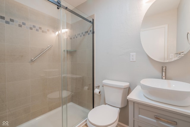 bathroom featuring toilet, an enclosed shower, and vanity