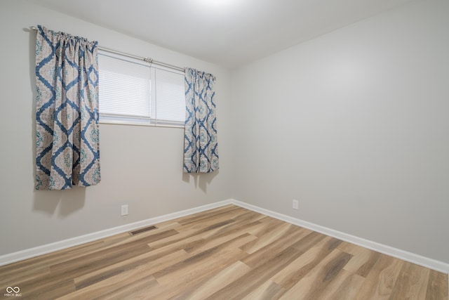 spare room featuring hardwood / wood-style floors