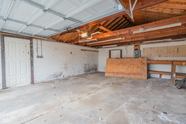 garage featuring electric panel and a garage door opener