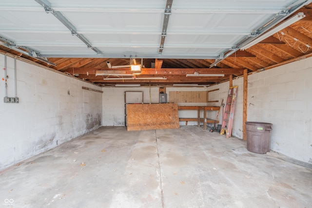 garage with electric panel and a garage door opener