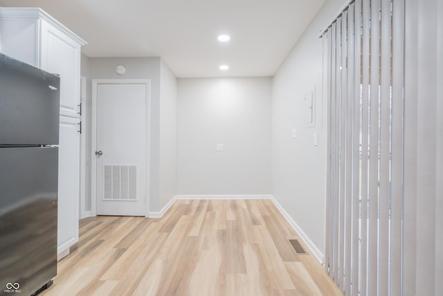 corridor with light wood-type flooring