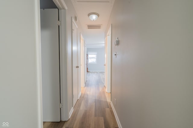 corridor with light wood-type flooring