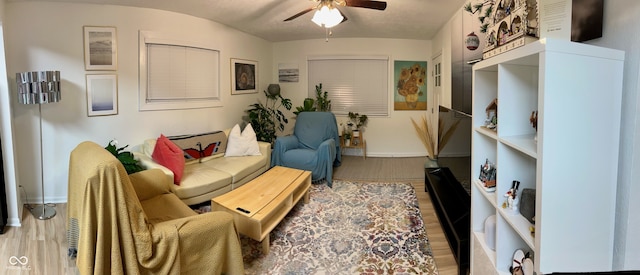 living room featuring hardwood / wood-style flooring and ceiling fan