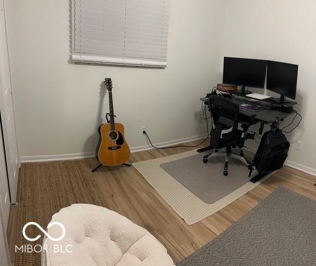 office space with baseboards and wood finished floors