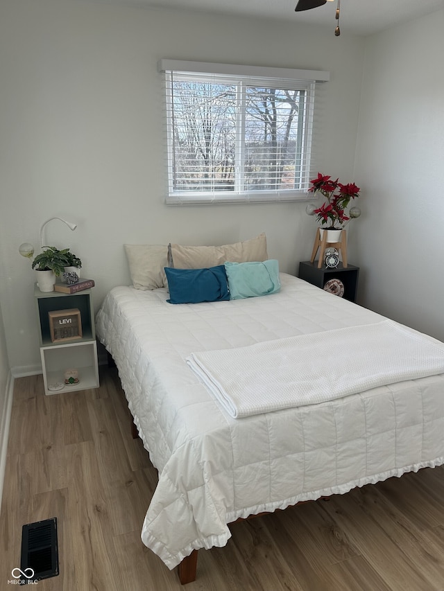 bedroom with visible vents and wood finished floors