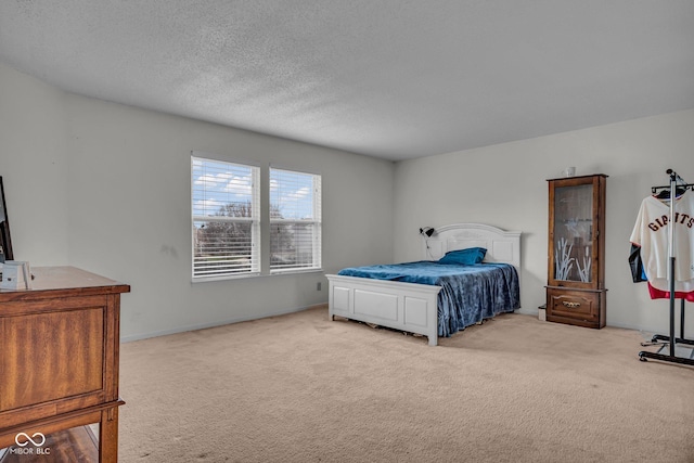 carpeted bedroom featuring a textured ceiling