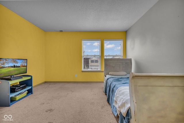 bedroom with carpet and a textured ceiling