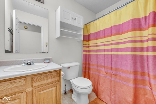 bathroom featuring vanity, toilet, and a textured ceiling