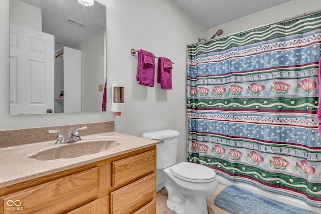 bathroom featuring walk in shower, vanity, a textured ceiling, and toilet