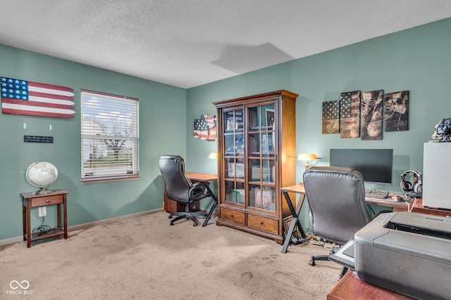 office area with carpet floors and a textured ceiling