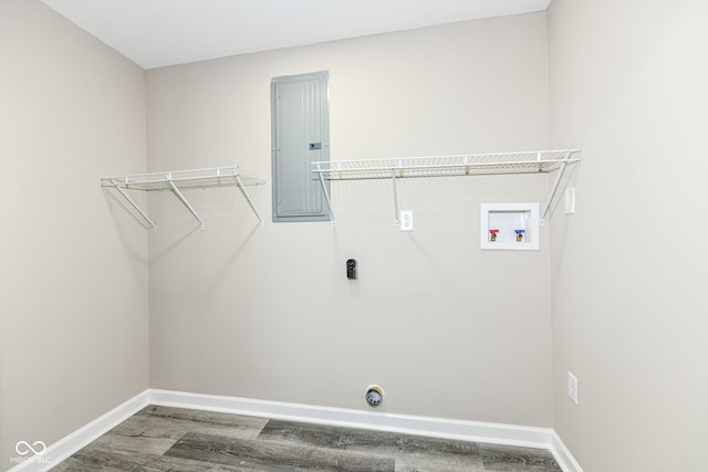 washroom featuring washer hookup, electric panel, and wood-type flooring