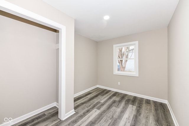 unfurnished bedroom featuring dark hardwood / wood-style floors and a closet