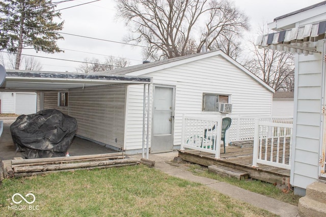 exterior space featuring a lawn, a wooden deck, and cooling unit