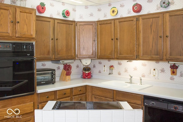 kitchen featuring black dishwasher and sink