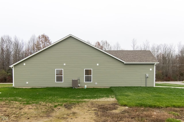 view of property exterior with a lawn and cooling unit