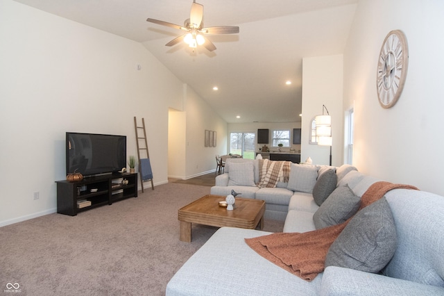 carpeted living room featuring ceiling fan and lofted ceiling