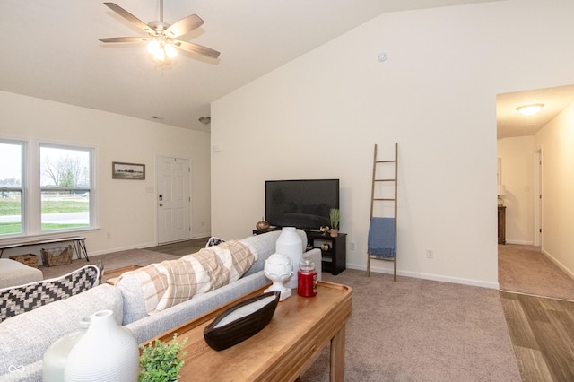 living room featuring high vaulted ceiling, light hardwood / wood-style flooring, and ceiling fan