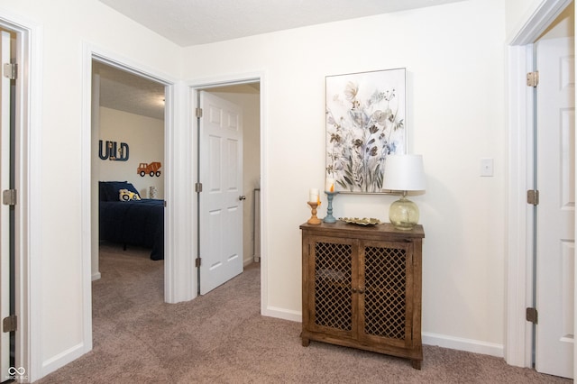 corridor with light colored carpet