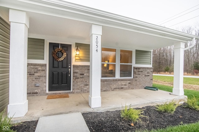 view of exterior entry featuring a porch