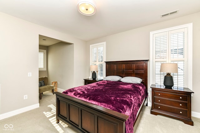 bedroom with light carpet, baseboards, and visible vents